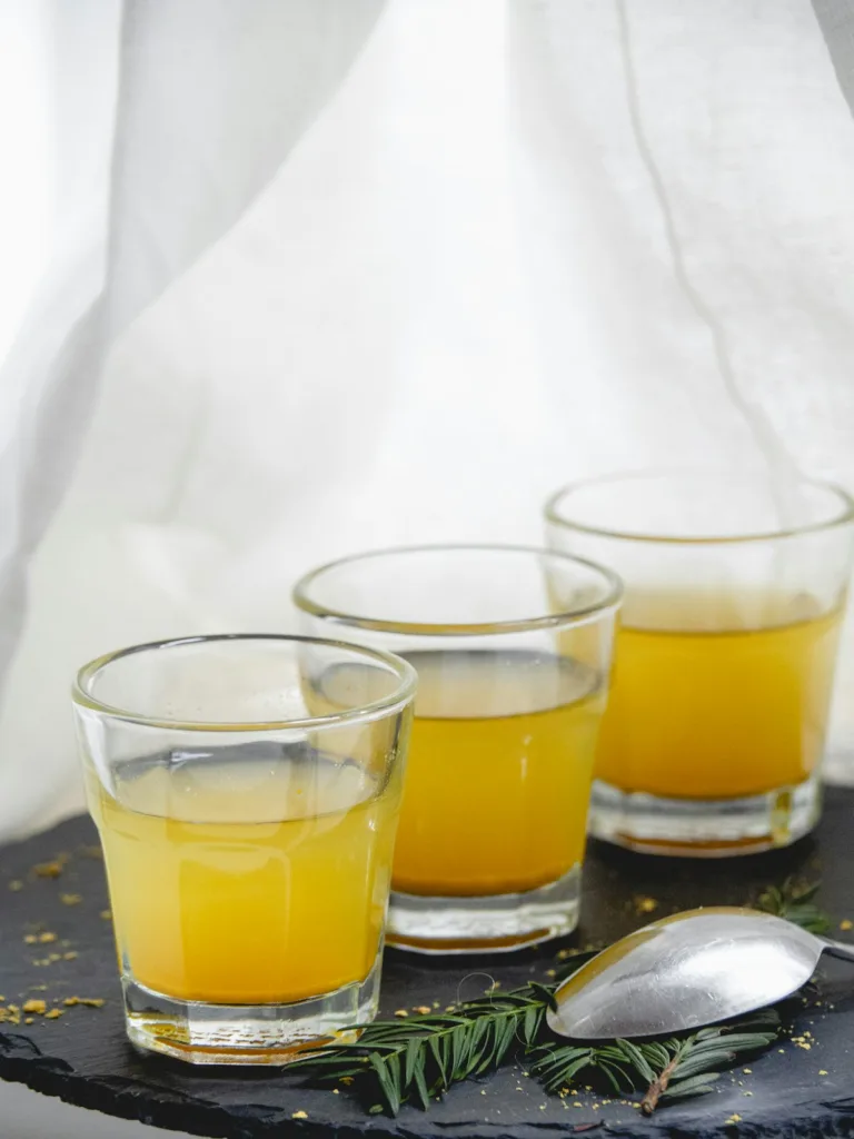 Ginger Shot Recipe (With a Batch Calculator for Any Number of Shots) 2 Three homemade ginger shots in small glasses, made with the ginger shot recipe